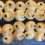 Batch of St. Lucia saffron buns cooling on a rack